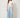 SR Light Blue Pants on model - front view with flat curved yoke waistband, piped seam and pleats