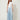 SR Light Blue Pants on model - front view with flat curved yoke waistband, piped seam and pleats