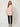 Pink Linen Bandi Coat on model - front view, fully closed gold zipper, chest flap pockets and small drawstring bows at the front waist