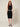 01333364 CHAIN CIRCLE BELT SILVER - front view on model, silver disc and ring chain belt at the waist over a black dress