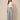 Grey chevron pleated wide-leg pants with front waist tie bow - model front