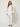 White sheer organza cover worn open over ivory camisole and white trousers - front