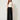 Black palazzo pants with sash tie and pleated panel - model front