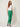 Green tailored trousers - three-quarter view on model