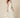 0133195002 model walking side - cream white sleeveless square-neck maxi dress