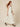 0133195002 model walking side - cream white sleeveless square-neck maxi dress
