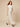 Cream crinkled wide-leg palazzo pants 113 cm - walking three-quarter view on model