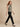 Sage green sleeveless cowl-neck top on model, side view