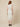 RM1528 white lady dress - back view on model, centre-back zipper, hook fastenings at the collar and vent at the back hem