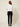 White Ag Bahar Coat on model - back view, plain white satin back with the wide collar band folded across the back neck, straight hem and sheer floral lace sleeves