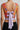 Orange floral cropped top on model, studio