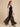 Black sheer organza palazzo pants on model, side view