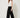 Black palazzo pants - model three-quarter view, pleated left leg