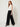 Black palazzo pants - model three-quarter view, pleated left leg