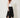 Black studded handkerchief-hem palazzo pants — model three-quarter view