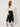 Black studded handkerchief-hem palazzo pants — model three-quarter view