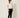 Nova Spring Blouse White on model - three-quarter view showing the boxy cut and embellished elbow sleeves