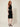 01333364 CHAIN CIRCLE BELT SILVER - three-quarter view on model, silver disc and ring chain belt over a black dress