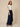 Navy blue abshar pants on model - three-quarter view showing the waterfall side drape