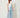 SR Light Blue Pants on model - three-quarter view showing the flat yoke and wide flowing legs