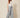 Grey chevron pleated wide-leg pants with front waist tie bow - model three-quarter view