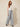 Grey chevron pleated wide-leg pants with front waist tie bow - model three-quarter view