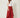 Red Edge Pant in red crinkle-textured fabric, three-quarter view on model showing draped edge side panel