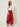 Red Edge Pant in red crinkle-textured fabric, three-quarter view on model showing draped edge side panel