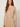 255403 ROSE PLEATED DRESS BEIGE - detail view of the round neckline, fine pleats and gold chain belt