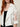 White Ag Bahar Coat - detail of the sheer white tulle sleeve with large 3D floral lace appliqué and the solid satin cuff band on the model