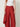Red Edge Pant detail, flat front waistband and crinkle wave texture with draped edge panel