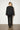 Elsa Rish Patineh Black Coat — back view on model showing the crinkled wave texture