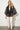 SR446 black cape jacket — closer view of the U-pattern lines, plain black pleated shawl band and front knot