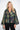 Maya Green Crocodile Coat — close-up of the woven folk tapestry pattern and collar on model