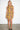 Lona Ochre Abron Dress — close-up of the ochre floral brocade on model