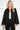 Elsa Rish Patineh Black Coat — close-up of the crinkled cloqué jacquard fabric and collarless neckline on model