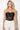 Black Draped Corset — close-up of the ruched satin bust and lace boning detail on model