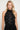 Endo Black Overall — close-up of the black disc appliqué bodice and halter collar on model