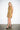 Lona Ochre Abron Dress — three-quarter view on model showing the sleeveless cut
