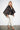 SR446 black cape jacket with metallic copper U-pattern — three-quarter view showing the wide kimono sleeves