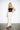 Black Draped Corset — three-quarter view on model showing the ruched satin and boning